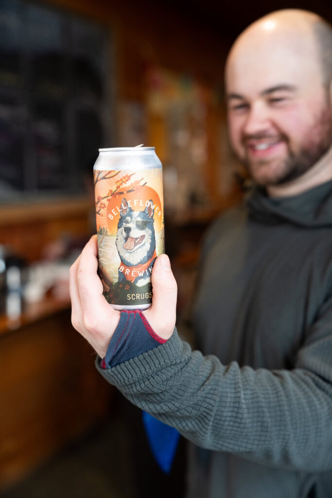Post hike beer at Stratton Brook Hut in maine for Winter Elopement 
