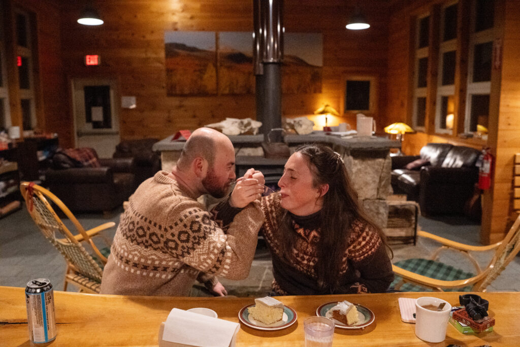 First bite of cake for winter Elopement with Maine Huts and trails at Stratton Brook Hut 