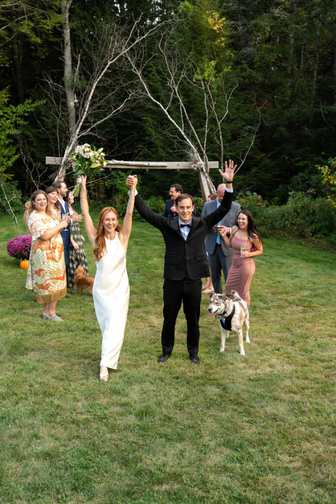 Couple walking down the aisle newly married during backyard Maine elopement 
how to elope in 4-8 weeks in Maine 
