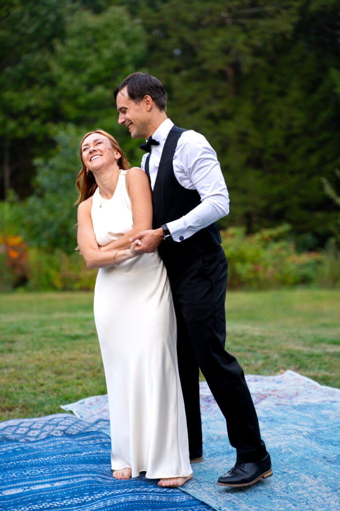 Couple laughing and dancing for intimate wedding elopement in  Maine 