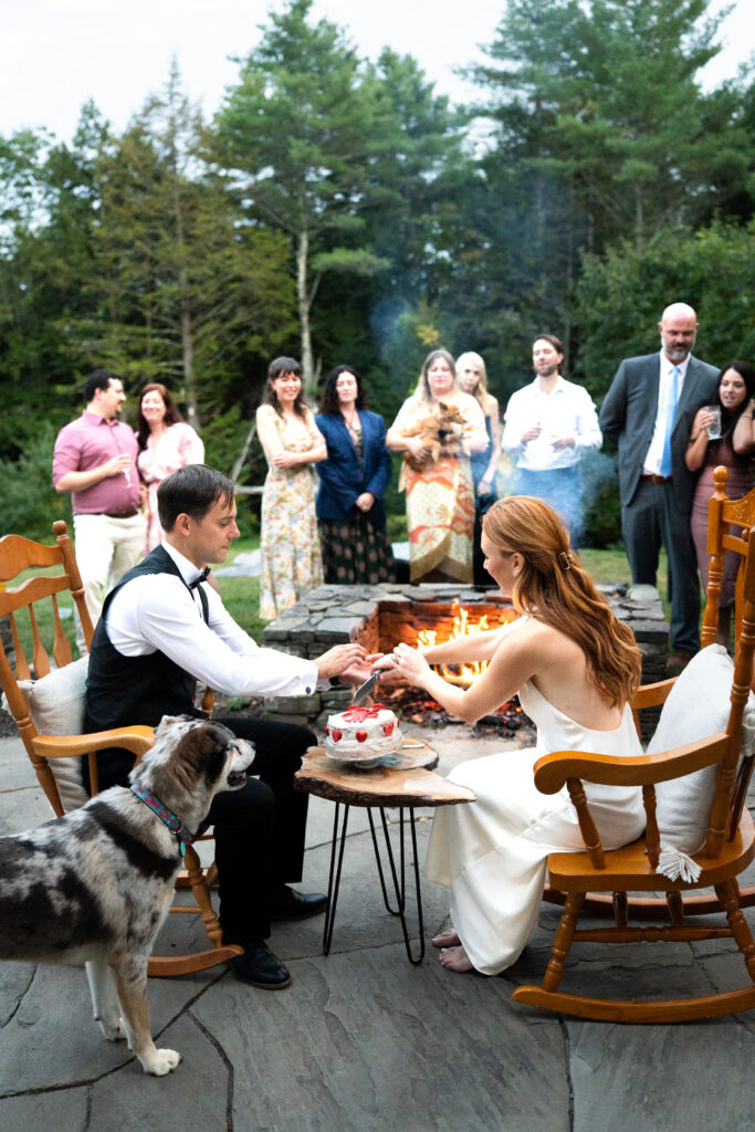 Couple cutting their lobster cake for their Maine elopement 