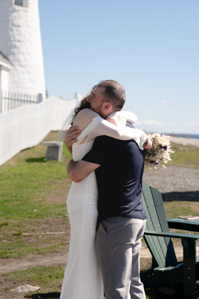  Intimate wedding ceremony at Pemaquid Point Lighthouse in Boothbay Harbor area with soft spring light and ocean backdrop
