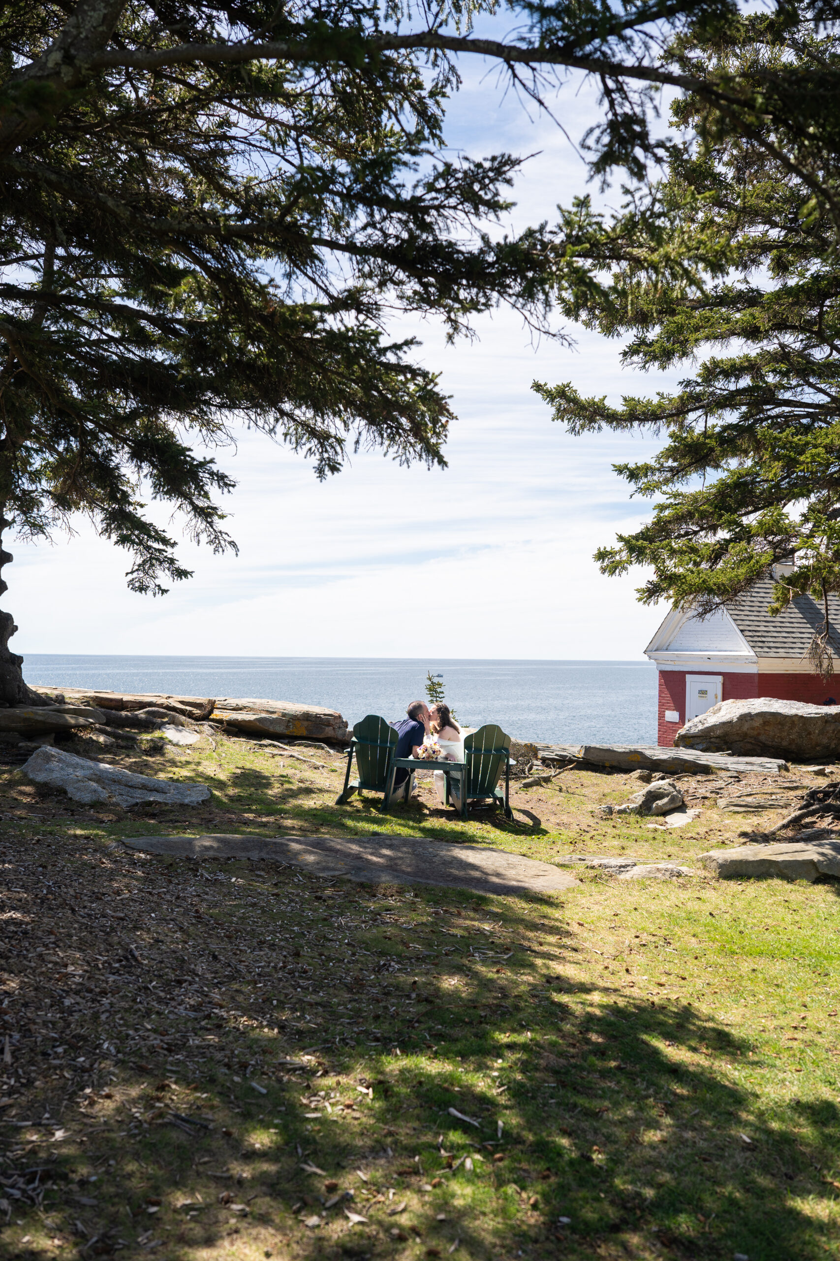 Intimate elopement celebration at Pemaquid Point Lighthouse with dramatic cliffs and spring ocean views near Boothbay Harbor