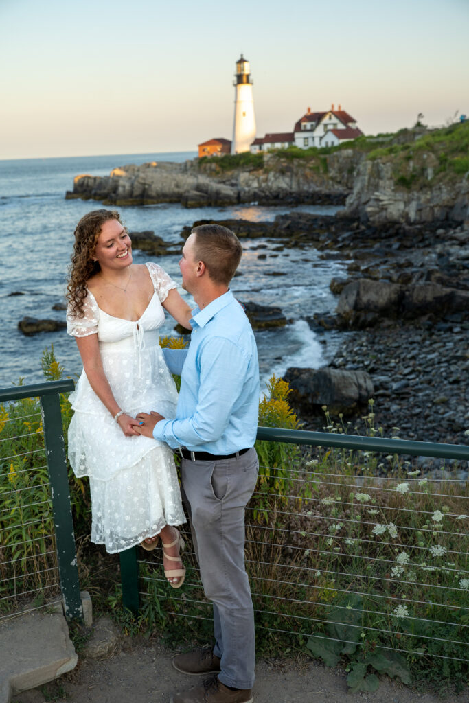 Couple exchanging vows at Portland Head Light in Cape Elizabeth during a sunny summer elopement overlooking the Atlantic Ocean
