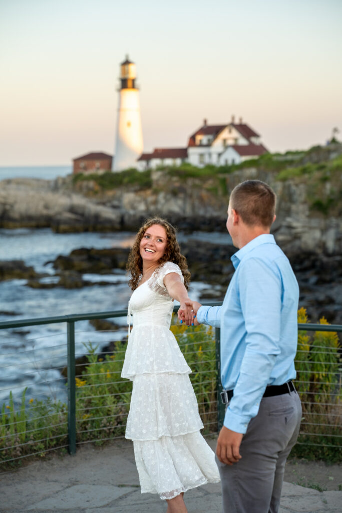  Couple exchanging vows at Portland Head Light in Cape Elizabeth during a sunny summer elopement overlooking the Atlantic Ocean